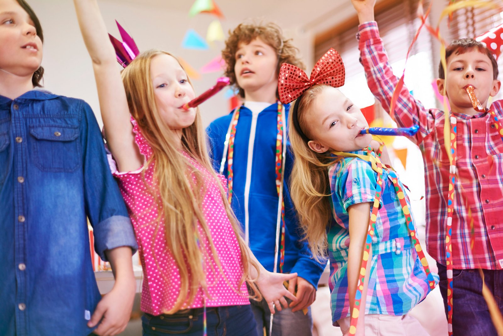 Kids mid-jump with big smiles, frozen in silly dance poses, while upbeat music plays in the background.