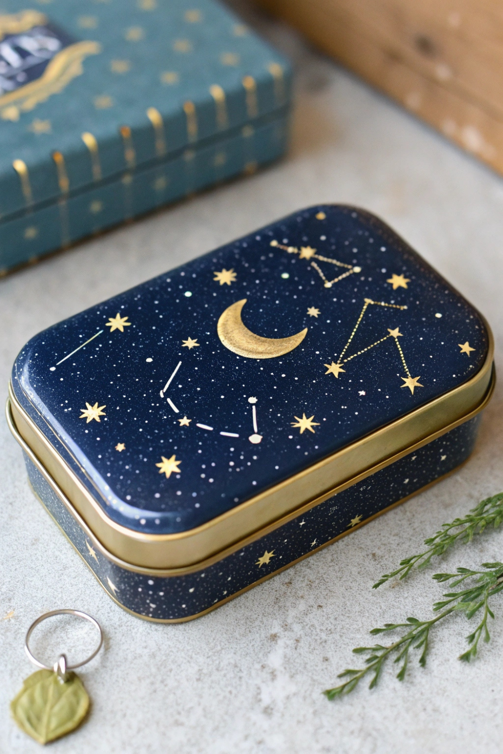 A dreamy tin painted in deep midnight blue with tiny gold stars and constellations, perfect for an astrology-loving couple!
