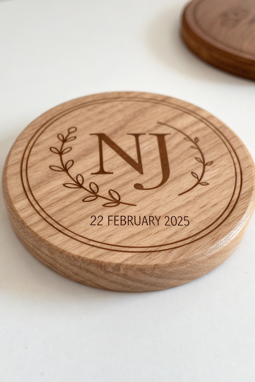 A chic wooden coaster, engraved with your initials and wedding date, resting under your guest’s coffee mug.