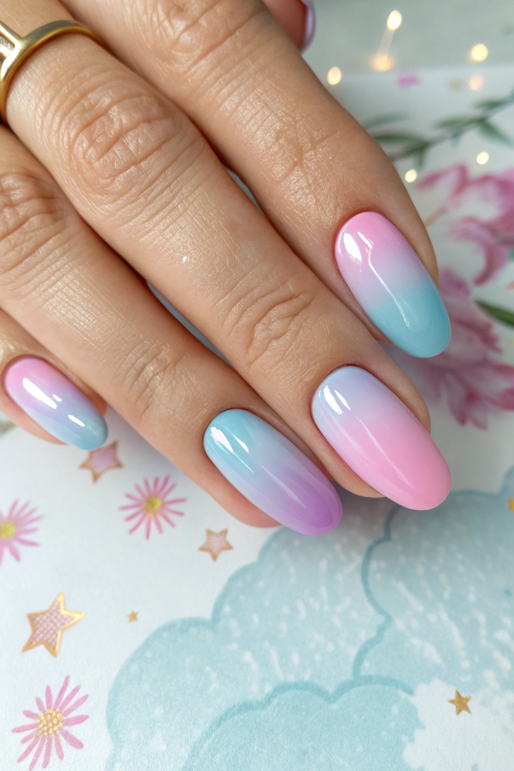 A seamless gradient of soft pastels, such as baby blue to lavender or peach to pink, blends beautifully across the nails.
