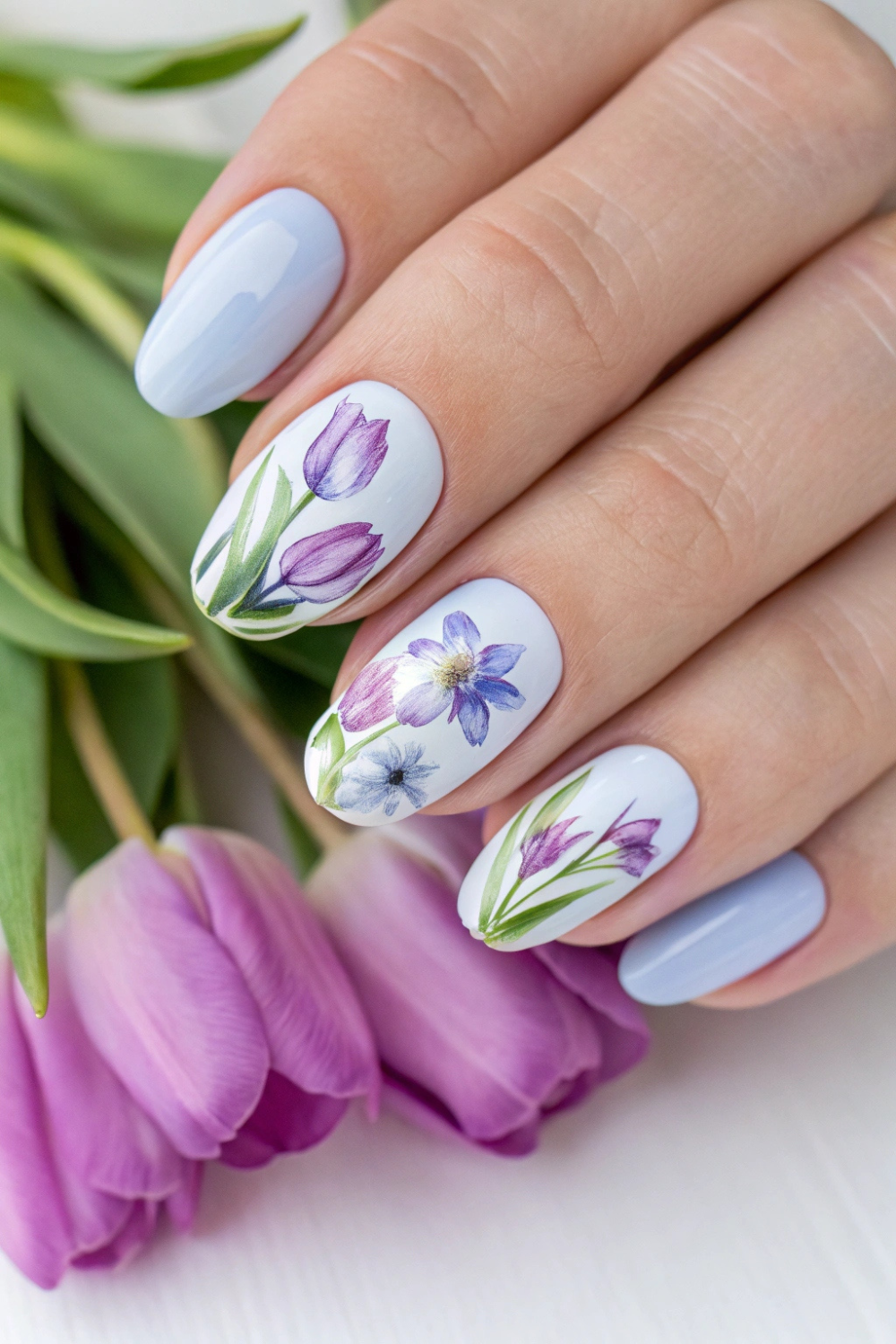 a light lavender or powder blue base with hand-painted tulips in a watercolor style. The petals blend seamlessly into the base, creating an effortlessly artistic finish.